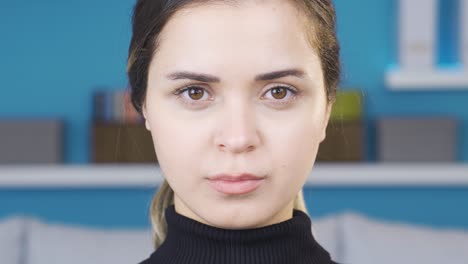 Close-up-of-young-woman-with-brown-eyes-looking-at-camera.